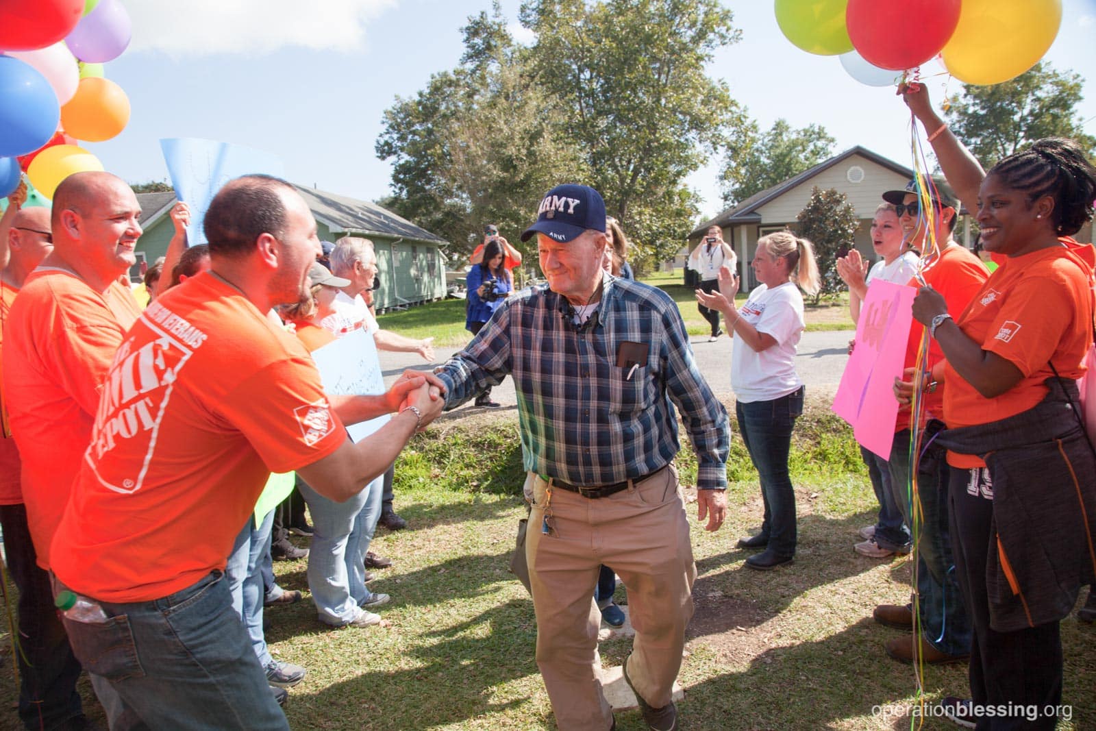 extreme-blessing-allen Allen approaches his new home makeover amidst balloons and cheering volunteers.