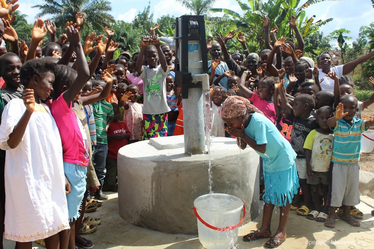 water-wells-liberia-girl-drink A young Liberian girl drinks deep from one of the new wells OBI built in her area.